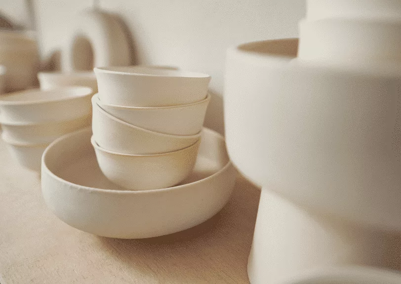 round ceramic dish and teabowls in pottery studio
